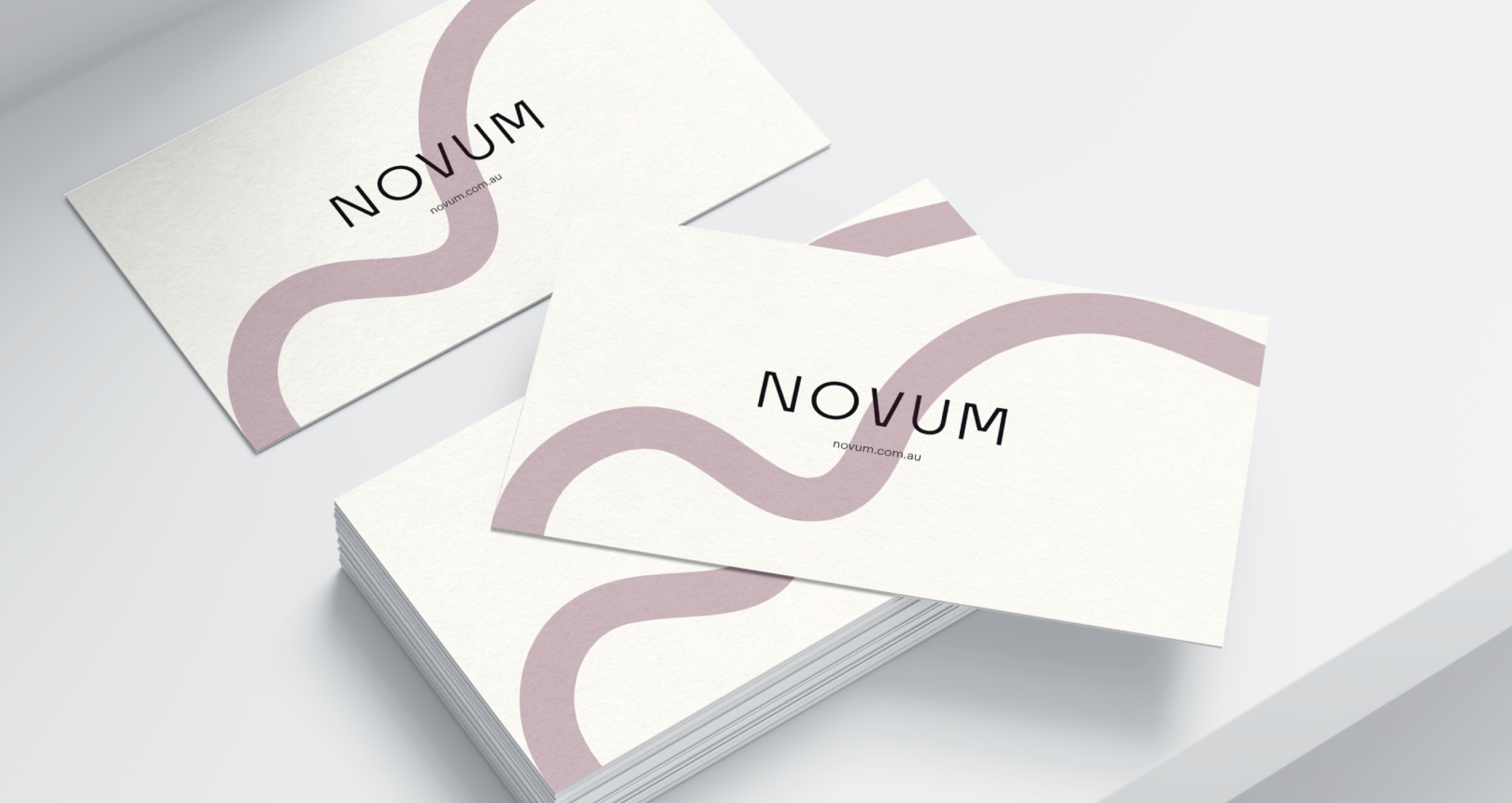 Novum business cards with pink wave logo.