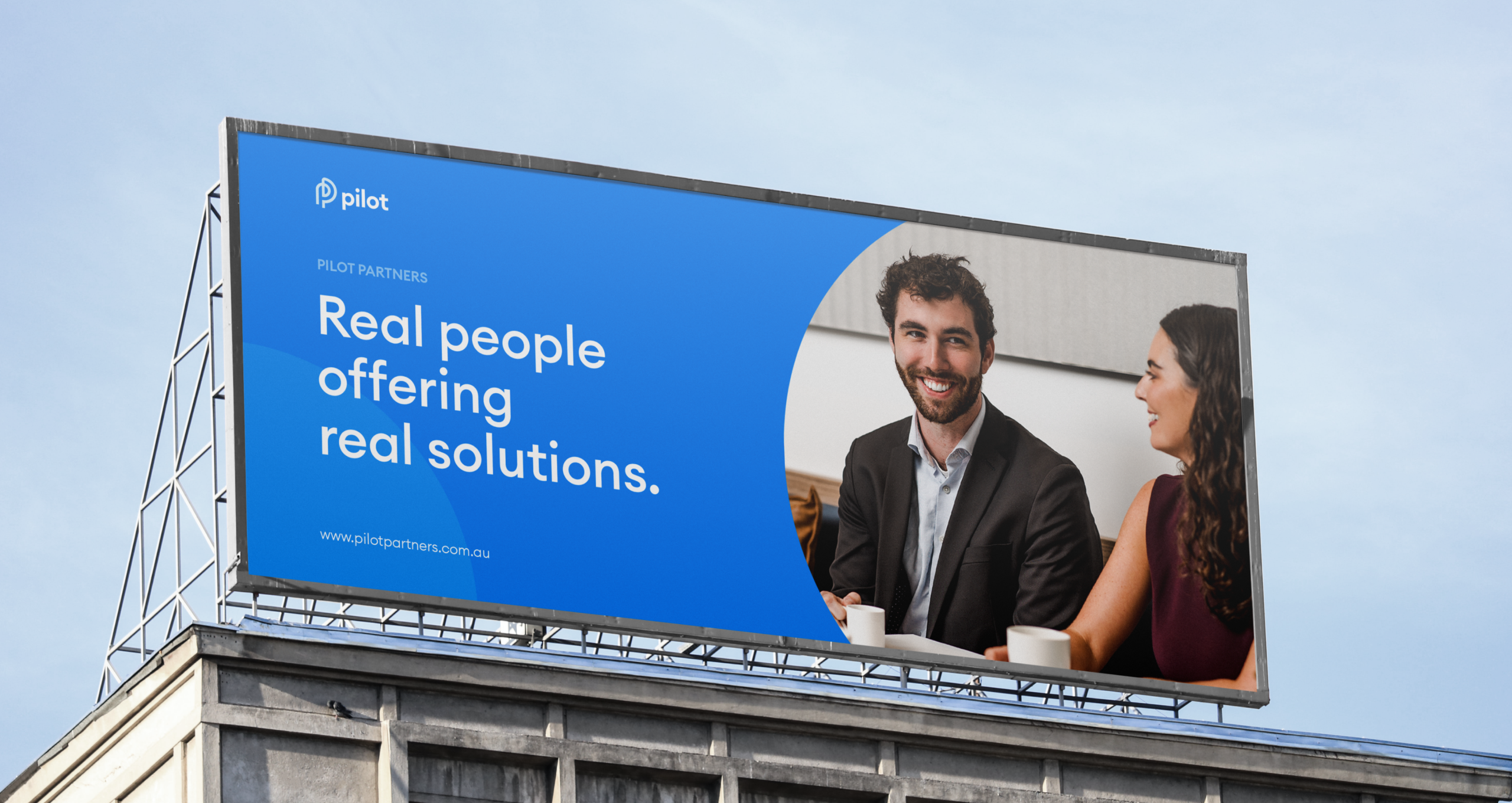 Pilot Partners billboard with real people.